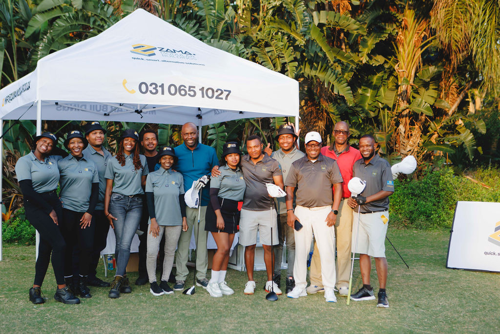 Golfers and event participants gathered at a branded course-side gazebo
