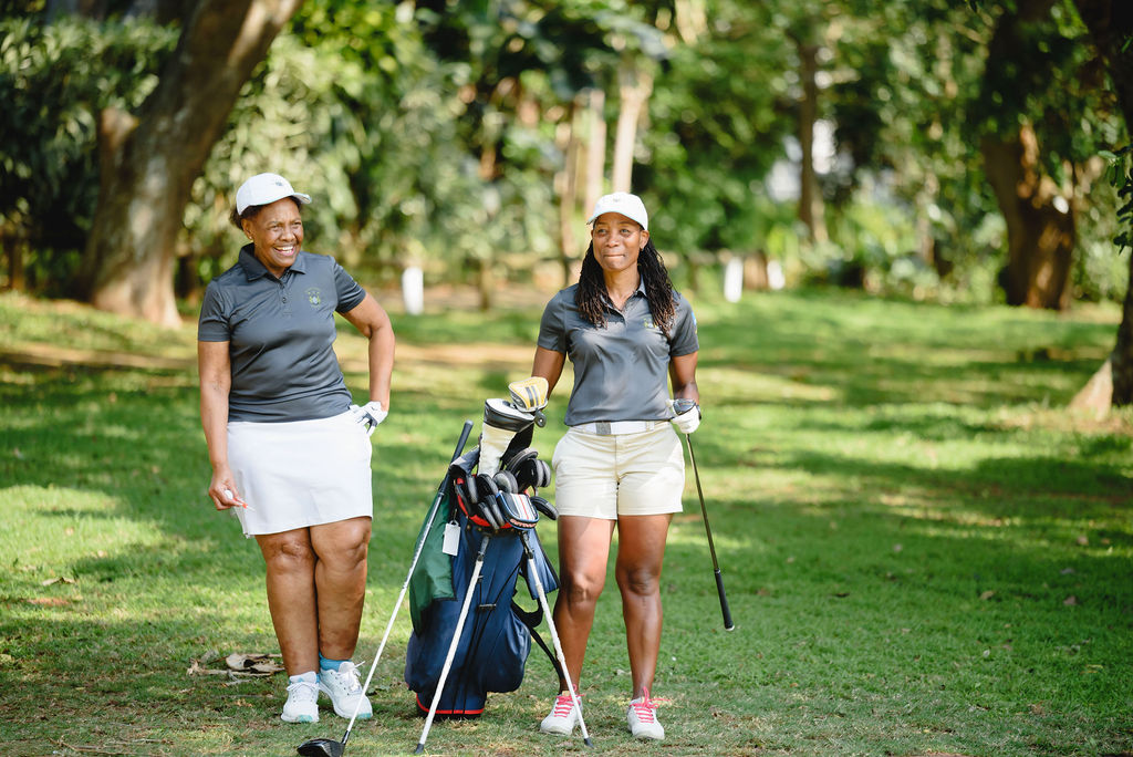 Two golfers with their golf bag on the fairway